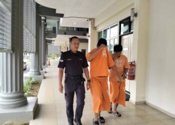 MUHAMMAD Afezi Alias (dua kiri) bersama Muhamad Ikhmal Aripin diiringi polis semasa menghadiri prosiding perbicaraan di Mahkamah Pasir Mas, Kelantan. - UTUSAN/ROHANA ISMAIL