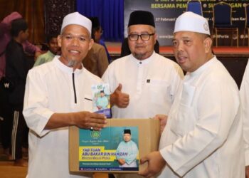 ABU Bakar Hamzah menyampaikan sumbangan kepada para penerima bersempena Program Imarah Ramadan di Dewan Warisan, Kangar, Perlis semalam.