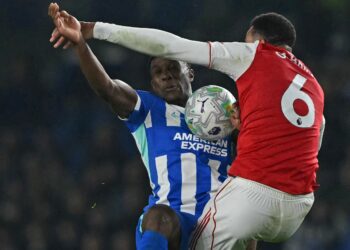 Penyerang Brighton, Danny Welbeck (kiri) bersaing dengan pemain pertahanan Arsenal, Gabriel Magalhaes dalam saingan Liga Perdana Inggeris di Stadium Komuniti American Express, semalam. - AFP