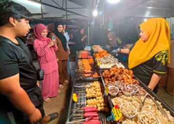 EDA Ezrin (kanan) melayani pelanggan yang menikmati colek dijualnya di Pok Wie Raja Sup Jam Besar, Kota Bharu, Kelantan. – UTUSAN/YATIMIN ABDULLAH