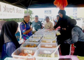 Siti Nur Shikin Ab. Aziz tidak menang tangan melayan pelanggan di gerainya yang terletak di tepi jalan di Taman Rambai Tengah, Bukit Rambai, Melaka.