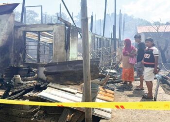 WARGA emas, Beah Awang (depan) bersama anak dan cucunya hanya mampu melihat rumah mereka musnah terbakar menjelang beberapa hari sebelum Aidilfitri di Kampung Pulau Ketam, Kuala Perlis semalam.-UTUSAN/MOHD. HAFIZ ABD. MUTALIB