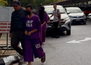 PELAKON wanita (belakang) dan suaminya diiringi polis untuk dibawa ke Mahkamah Majistret Seremban hari ini bagi permohonan reman ke atas mereka.