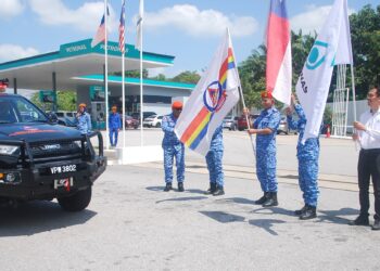 GHAZALI Abd. Rahman (tiga dari kiri) mengibar bendera sebagai simbolik melepaskan aset APM pada pelancaran Op Prihatin Zon Selatan di Stesen Minyak Petronas Lebuh SPA, Ayer Keroh, Melaka. - UTUSAN/AMRAN MULUP
