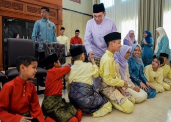 ANWAR Ibrahim bersalaman dengan kanak-kanak ketika mengunjungi kediaman Johari Abdul.-FB ANWAR IBRAHIM.