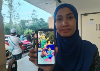 NOR Fatin Mohd. Azhar menunjukkan foto Mohamad Shakiran Saidi yang maut dalam kemalangan ketika ditemui di Unit Forensik Hospital Setiu, Setiu, Terengganu. - UTUSAN / WAN ZURATIKAH IFFAH WAN ZULKIFLI