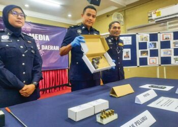 TENGKU Mohd. Faizal Tengku Yeng (tengah) menunjukkan pistol yang dirampas serta beberapa barangan lain dalam kejadian tembak di Kampung Permatang Durian, Padang Serai pada sidang akhbar di IPD Kulim, Kedah, semalam.