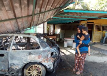 NORMAIZURA M.Raduan mendukung Mohd. Amir KETIKA melihat sebuah kereta Proton Satria miliknya yang terbakar dalam kejadian kebakaran di Kampung Sri Sentosa, Bachok, Kelantan hari ini.