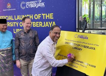 Zambry Abdul Kadir menurunkan tanda tangan di atas plak sebagai simbolik Majlis Perasmian Naik Taraf Perpustakaan Digital University of Cyberjaya (UoC), Cyberjaya, hari ini.