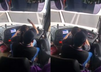 TANGKAP layar video menunjukkan seorang wanita 'memandu' sebuah bas ekspres sambil diriba oleh seorang lelaki yang tular di media sosial.