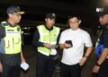 AZMAN Adam (kiri) melakukan pemeriksaan terhadap pemandu pada Operasi Bersepadu Bersama JPJ di susur keluar CIQ BSI, Johor Bahru disini. - UTUSAN/ RAJA JAAFAR ALI