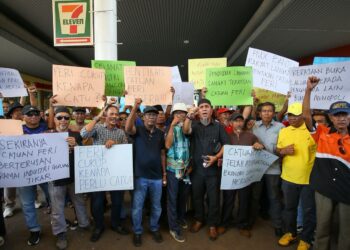 ZURAIDI Rahim (tengah) bersama penduduk dan pemain industri pelancongan mendesak agar catuan perkhidmatan feri dihentikan segera pada himpunan aman di Jeti Kuah, Langkawi. - UTUSAN/ SHAHIR NOORDIN