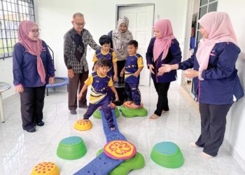 MOHAMAD Zaki Ismail (dua, kiri) bersama guru-guru melihat anak-anak autisme melakukan aktiviti disediakan di tabika khas autisme di Tabika Kemajuan Masyarakat  Tunas Istimewa, Kuala Perlis, semalam. 
– UTUSAN/MOHD. HAFIZ ABD. MUTALIB