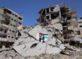 PENDUDUK Gaza melukis mural di atas runtuhan bangunan yang musnah semasa perang, di kem pelarian Shati di Gaza City.- AFP