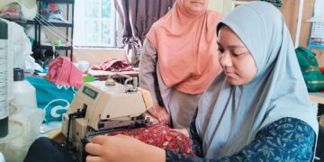 ALIA Batrisyia Mazlan mencari pendapatan dengan mengambil upah mengelim baju sebanyak RM2 sehelai di rumahnya di Kampung Simpol, Pasir Mas, Kelantan. – UTUSAN/ROHANA ISMAIL