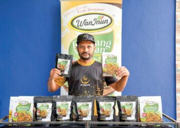 ABDUL Hafiz Azam menunjukkan antara produk rendang maman keluaran Wan Inun.