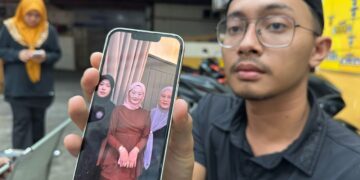 MUHAMMAD Faris Zulkifly menunjukkan gambar Allahyarham Nurfisya (tengah) ketika ditemui di Unit Forensik HRPZ II, Kota Bharu, Kelantan.