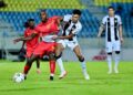 PEMAIN Terengganu FC (TFC), Azam Azmi (dua dari kanan) mengasak pemain Imigresen FC dalam saingan Liga Super di Stadium Sultan Mizan Zainal Abidin, Kuala Nerus, Terengganu, malam ini. - UTUSAN/PUQTRA HAIRRY