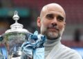 Pep Guardiola memegang Piala FA selepas pasukan bimbingannya menewaskan Chelsea 1-0 pada perlawanan akhir di Stadium Wembley, London, kelmarin. - AFP   
