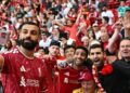 Penyerang Liverpool, Mohamed Salah berswafoto bersama penyokong-penyokong The Reds selepas berakhir perlawanan menentang Brentford di Anfield, semalam. - AFP