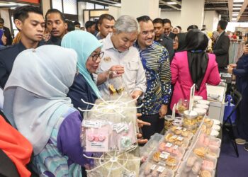 AHMAD Zahid Hamidi diiringi oleh Pengerusi MARA, Datuk Dr Asyraf Wajdi Dusuki melawat reruai pameran dan jualan sempena Majlis Pelancaran Ekosistem Halal Mara di Pusat Dagangan Dunia (WTCKL) di sini hari ini. -UTUSAN/ AMIR KHALID