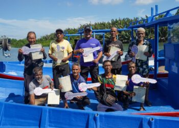 PARA nelayan bergambar kenangan selepas menerima bot dan enjin baharu sempena program 'Sambutan Aidiladha Bersama Komuniti Nelayan' di Pulau Pinang, semalam.