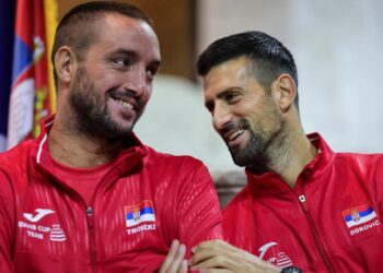 Viktor Troicki (kanan) bersama Novak Djokovic tersenyum ketika majlis undian rasmi saingan Piala Davis antara Serbia dan Greece di Aleksandar Nikolic Hall, Belgrade, September tahun lalu. - AFP