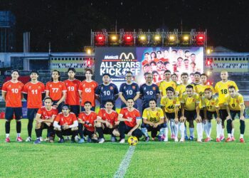 PEGAWAI McDonald’s Malaysia bersama pasukan Malaysia All Stars (jersi kuning) dan Mekdi All Stars pada perlawatan amal bagi mengumpul dana di Stadium Merdeka, kelmarin. – MINGGUAN/ SHIDDIEQIIN ZON