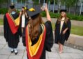 PELAJAR bergambar selepas menerima ijazah di Universiti Bolton. - AFP