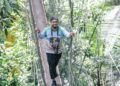 PENGUNJUNG melalui jambatan di Titian Kanopi Seberang Ara hutan tropika Taman Negara Kuala Tahan di Jerantut, Pahang.