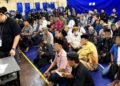 SEBAHAGIAN individu yang ditahan pihak berkuasa dalam serbuan satu program dianjurkan di Dewan Sekolah Menengah (SM) Lok Yuk, Likas, Kota Kinabalu, Sabah semalam. - GAMBAR IHSAN POLIS