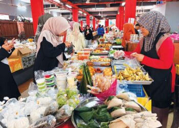 PELANGGAN membeli kuih RM1 di Pasar Siti Khadijah, Kota Bharu, Kelantan.