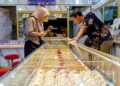 PEMBELI melihat emas di kedai emas. - GAMBAR HIASAN.
