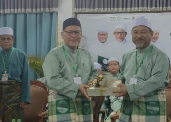 MOHD. Amari Nik Abdullah (kiri) menyerahkan cenderamata kepada Mohd. Nassuruddin Daud yang hadir merasmikan Mesyuarat Agung Pas Kawasan Pengkalan Chepa, Kota Bharu, Kelantan-UTUSAN/YATIMIN ABDULLAH.