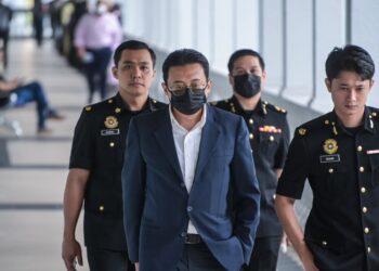 ILIYAS Jamil yang didakwa atas tujuh pertuduhan meminta dan menerima rasuah ketika diiringi pegawai Suruhanjaya Pencegahan Rasuah Malaysia (SPRM) di Mahkamah Sesyen Kuala Lumpur, di sini hari ini. - UTUSAN/SYAKIR RADIN
