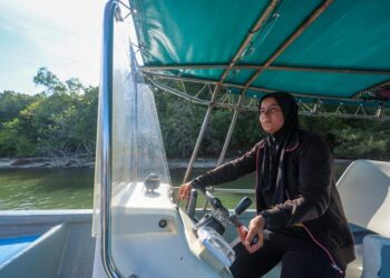 SITI Aisyah Umairah Tan Abdullah kini bekerja sebagai pemandu bot  selepas memeluk Islam sejak 14 tahun lalu dan menetap di Merang, Setiu, Terengganu. -UTUSAN/PUQTRA HAIRRY