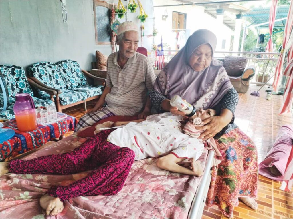 Malaysian couple cares for severely disabled daughter for over 40 years