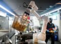 LONJAKAN kos buruh menyebabkan robot digunakan di kedai. - AFP