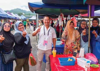 DANNI Rais sempat bergambar bersama pengunjung di Pasar Tani Kuala Klawang, Jelebu, baru-baru ini.