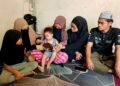 Nur Syafiqah Mohd. Khair (dua dari kanan) bersama adik-beradiknya memikul tanggungjawab menjaga Muhammad Harith Syauqi yang menghidap sindrom Down serta autisme di Felda Lurah Bilut, Bentong, Pahang.