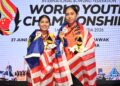 Gandingan negara, Adania Mohd. Redzwan (kanan) dan Adelia Nur Irwan Syazalee meraikan kejayaan muncul juara beregu perempuan Kejohanan Boling Remaja Dunia IBF selepas menewaskan wakil Amerika Syarikat pada aksi final di Megalanes Sarawak, Kuching, pada Ahad. - FOTO MTBC