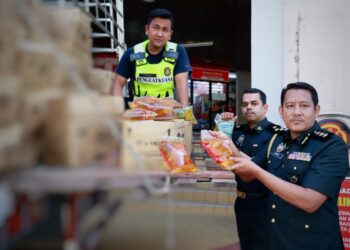 ASWADI Jaafar (kanan) bersama pegawainya menunjukkan minyak masak yang dirampas semasa sidang media di pejabat KPDN Kelantan, Kota Bharu, Kelantan.UTUSAN/KAMARUL BISMI KAMARUZAMAN.