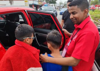 MOHAMAD HANIFAH menasihatkan dua beradik lelaki yang melarikan diri dari rumah sejauh 20 kilometer ketika berkempen di Taman Gadong Jaya, Labu, di sini hari ini. -UTUSAN