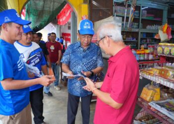 JALALUDDIN Alias (dua dari kanan) beramah mesra dengan peniaga di sekitar Pekan Simpang Pertang, Jelebu hari ini.
