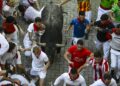 PESERTA berlari bersama sekumpulan lembu jantan semasa acara larian lembu jantan kelima sempena Festival San Fermin di Pamplona, utara Sepanyol semalam. - AFP.