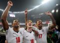 PEMAIN tengah England, Jude Bellingham (kiri) bersama Anthony Gordon (tengah) dan Morgan Rogers meraikan kejayaan mereka layak beraksi di peringkat suku akhir Piala Dunia 2026. - AFP
