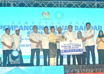 AHMAD Zahid Hamidi (tengah) menyerahkan replika cek Agihan Keuntungan Boleh Agih Interim 1/2026, FELCRA Berhad kepada wakil Felcra di Stadium Tun Razak Jengka di Bandar Tun Abdul Razak di Maran, Pahang. - UTUSAN/SHAIKH AHMAD RAZIF