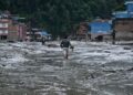 SEORANG penduduk meredah jalan yang diliputi lumpur tebal selepas banjir kilat dan bencana tanah runtuh melanda daerah Nuwakot, Nepal, Rabu lalu.- AFP