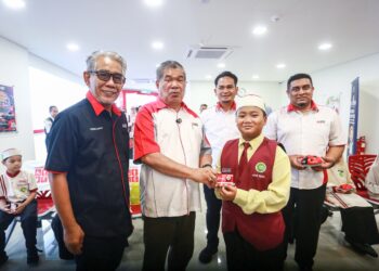MOHAMAD Sabu menyampaikan sumbangan kepada pelajar Sekolah Rendah Integrasi Teras Islam (SRITI) pada Majlis Pelancaran Cawangan Agrobank Bandar Botanik, di Klang. - UTUSAN / AFIQ RAZALI