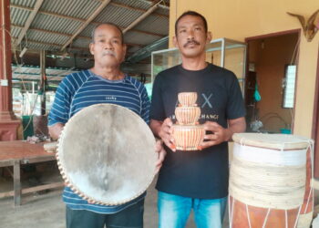 HAPIZI Hussin (kanan) bersama Hussin A. Ghani menunjukkan rebana dan alat muzik tradisional yang dihasilkan mereka di Kampung Gong Ubi Keling, Besut, Terengganu. – UTUSAN/WAN ZURATIKAH IFFAH WAN ZULKIFLI